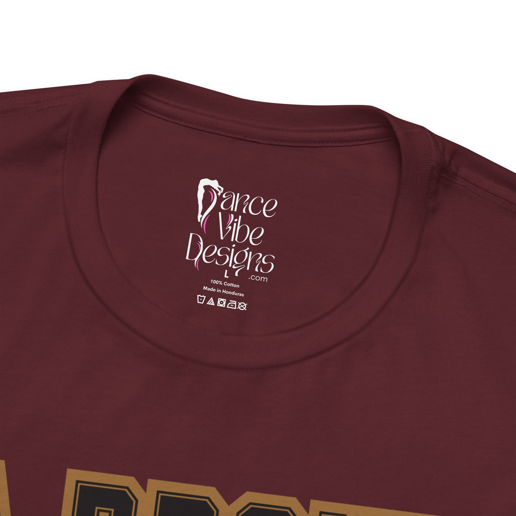 Close-up of a maroon crewneck t-shirt's inner neck label printed with the brand Dance Vibe Designs logo above the care instructions.