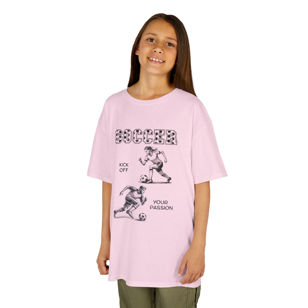 Young girl wearing a youth Gildan 5000B heavy cotton t-shirt in light pink with a Soccer text and graphic