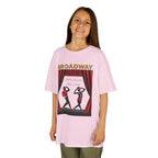 Young girl wearing a youth Gildan 5000B heavy cotton t-shirt in light pink with a Broadway text and graphic