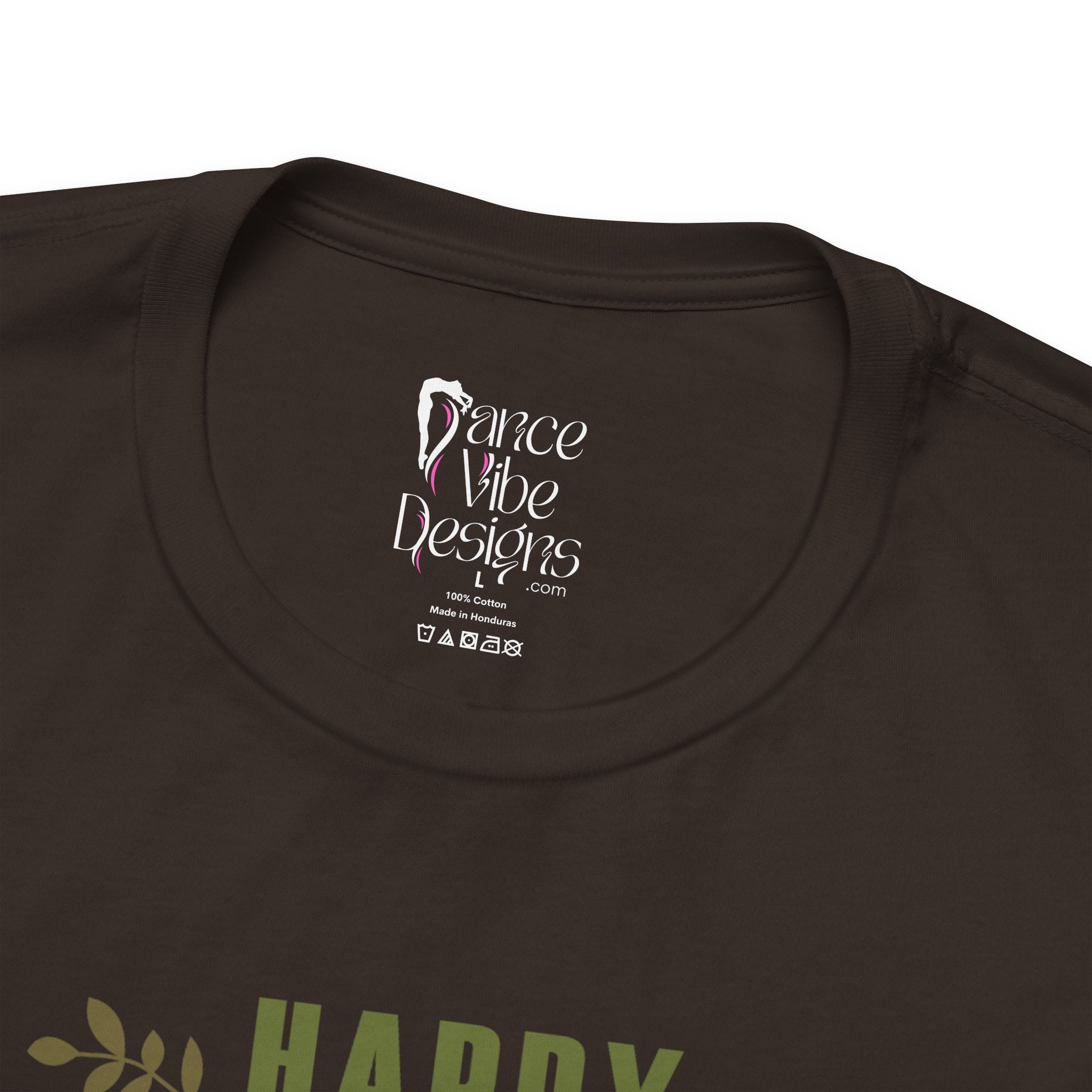 Close-up of a brown crewneck t-shirt showing the inner neck label with Dance Vibe Designs LLC printed in white.