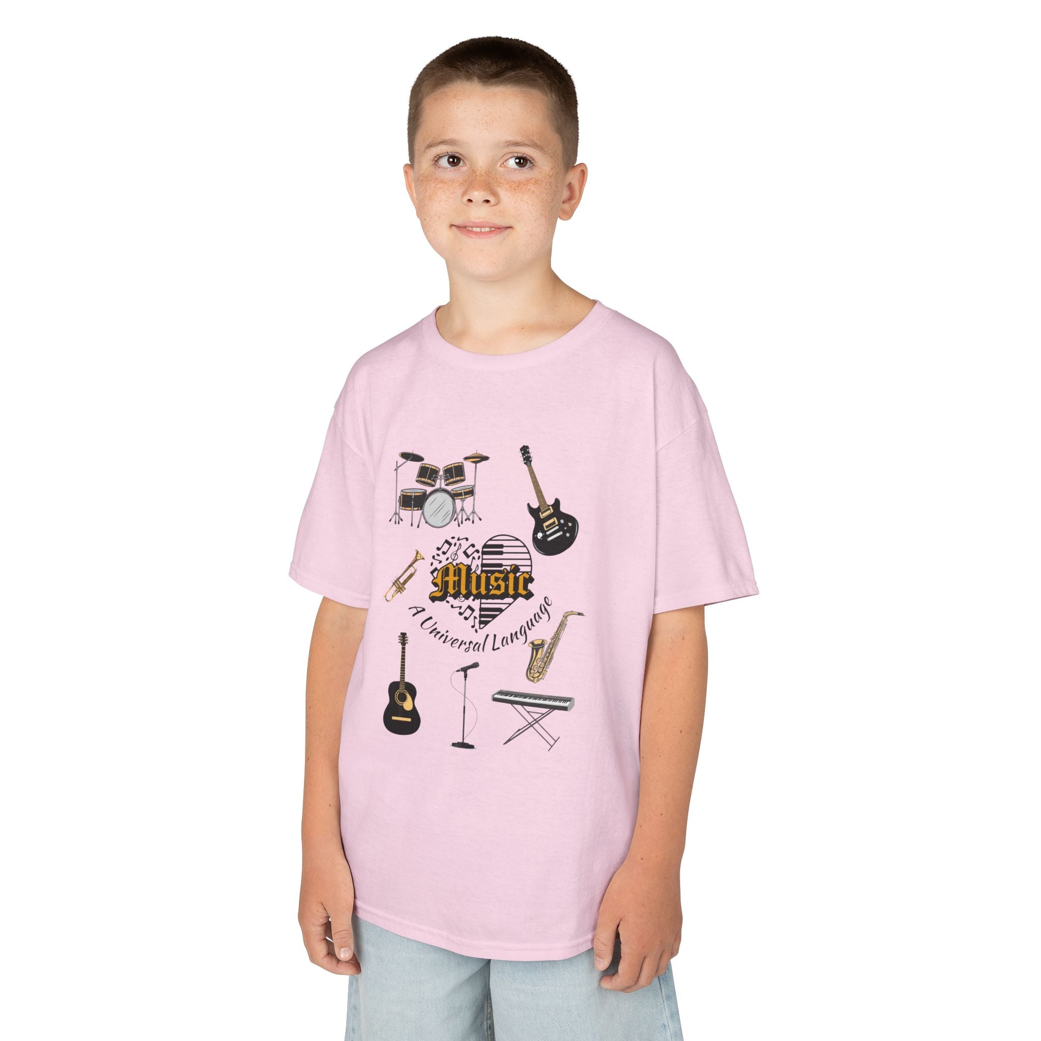 Young boy wearing a youth Gildan 5000B heavy cotton t-shirt in light pink with a Music A Universal Language theme