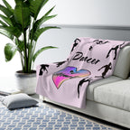 Pink sherpa fleece throw blanket featuring Just a Dancer at Heart text with heart and dancer graphics draped over a couch in a living room