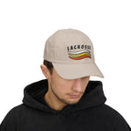 Man wearing a stone embroidered classic dad cap hat with a Lacrosse text and graphic