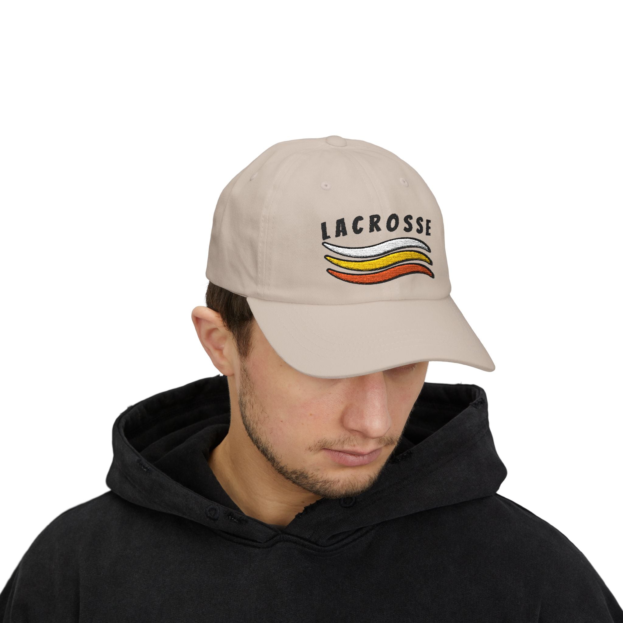 Man wearing a stone embroidered classic dad cap hat with a Lacrosse text and graphic