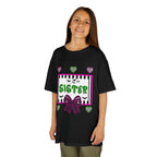 A young girl wearing a black t-shirt featuring a colorful Beetlejuice inspired Halloween-themed graphic with the word SISTER on the front. 