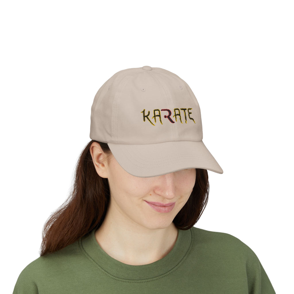 Woman wearing a stone cap with KARATE embroidered in colorful letters.