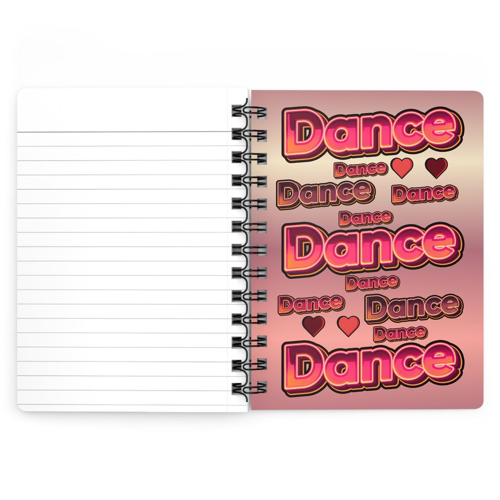 An open spiral-bound notebook with lined pages on the left and a printed cover design on the right featuring the word 'Dance' repeated in large pink and red bubble letters over a pink-to-peach gradient background.