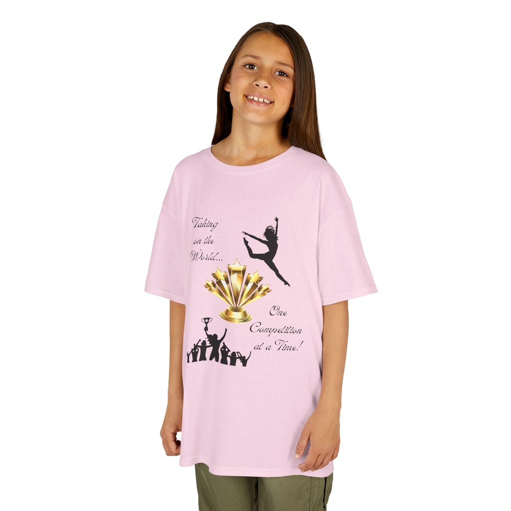 Young girl wearing a youth Gildan 5000B heavy cotton t-shirt in light pink with a Dance Competition theme