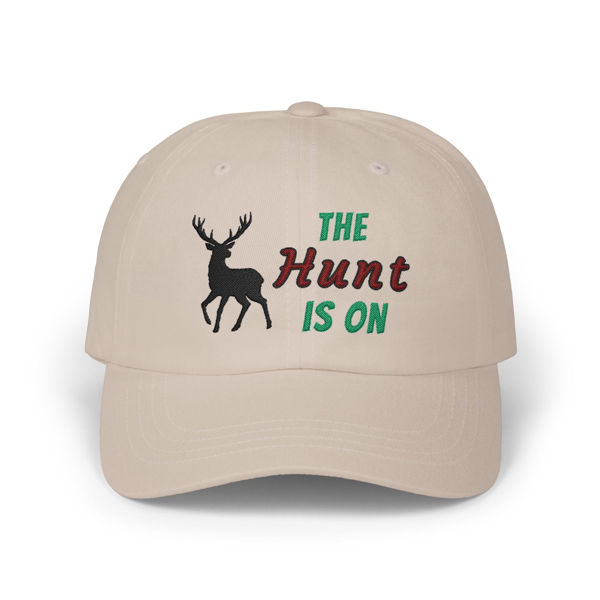 Stone cap with an embroidered deer silhouette and The Hunt Is On text.