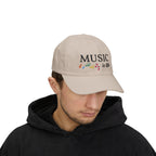 Man wearing a stone embroidered classic dad cap hat with a Music is Life text and graphic