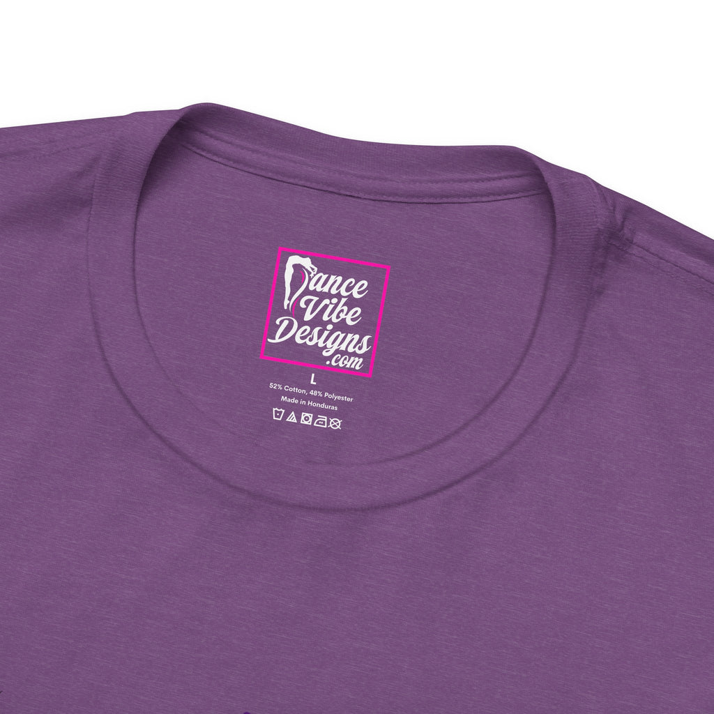 Close up view of a custom Dance Vibe Designs neck label shown over the t-shirt care instructions.