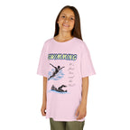 Young girl wearing a youth Gildan 5000B heavy cotton t-shirt in light pink with a Swimming text and graphic