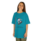 Young girl wearing a youth Gildan 5000B heavy cotton t-shirt in tropical blue featuring a girl Skateboarding