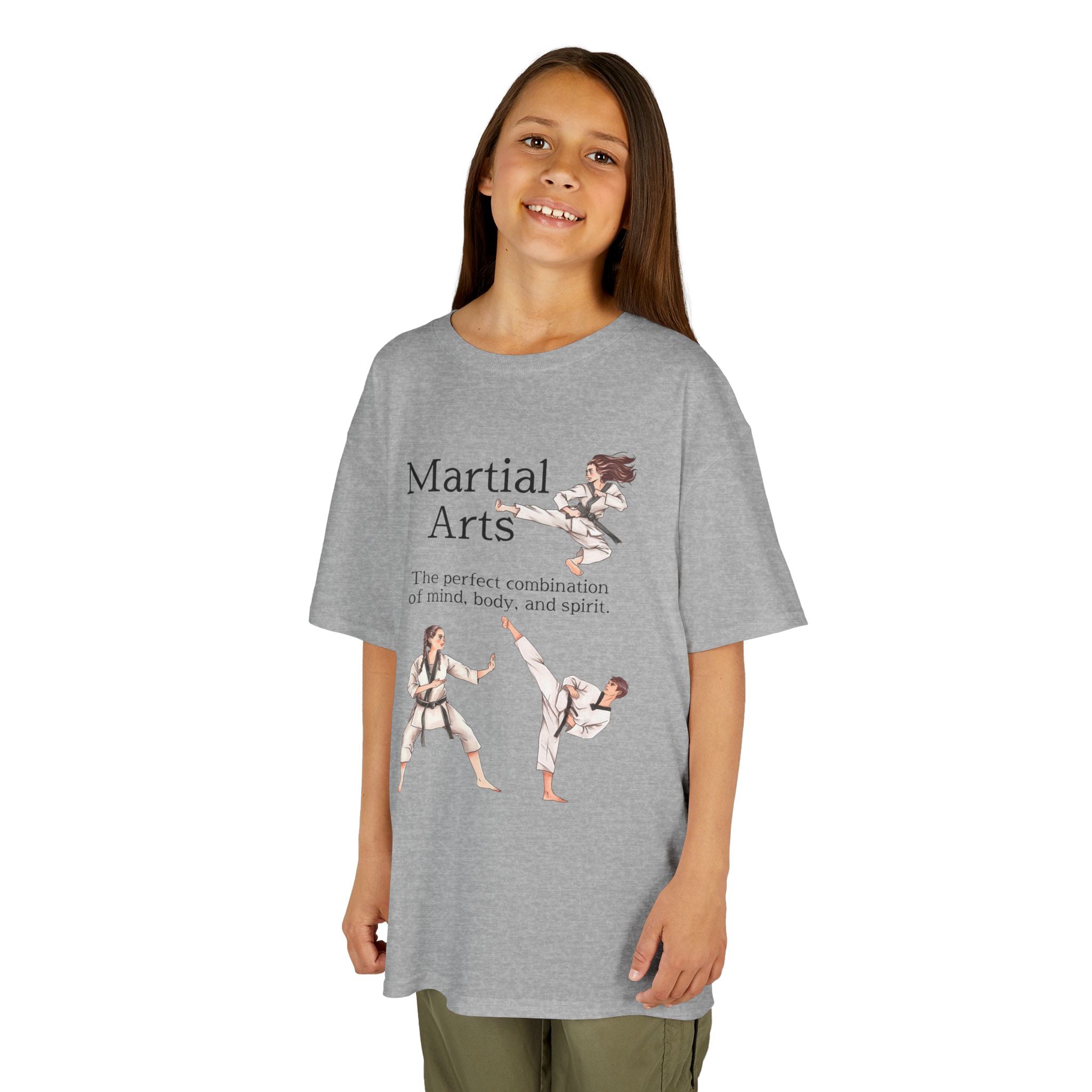 Young girl wearing a youth Gildan 5000B heavy cotton t-shirt in sport grey with a Martial Arts text and graphic