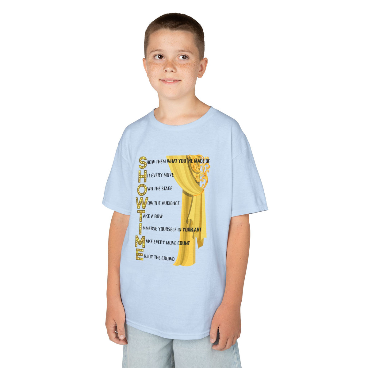 Young boy wearing a youth Gildan 5000B heavy cotton t-shirt in light blue with a Showtime text and graphic 