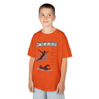 Young boy wearing a youth Gildan 5000B heavy cotton t-shirt in tennessee orange with a Swimming text and graphic