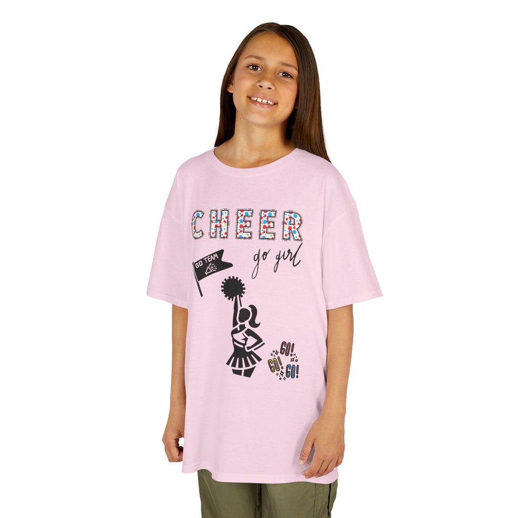 Young girl wearing a youth Gildan 5000B heavy cotton t-shirt in light pink with a Cheerleader theme