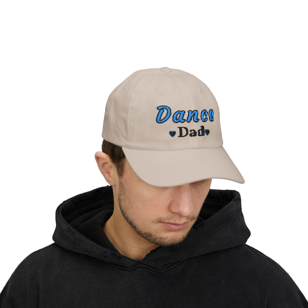 A man wearing a stone baseball cap with Dance Dad embroidered on the front.