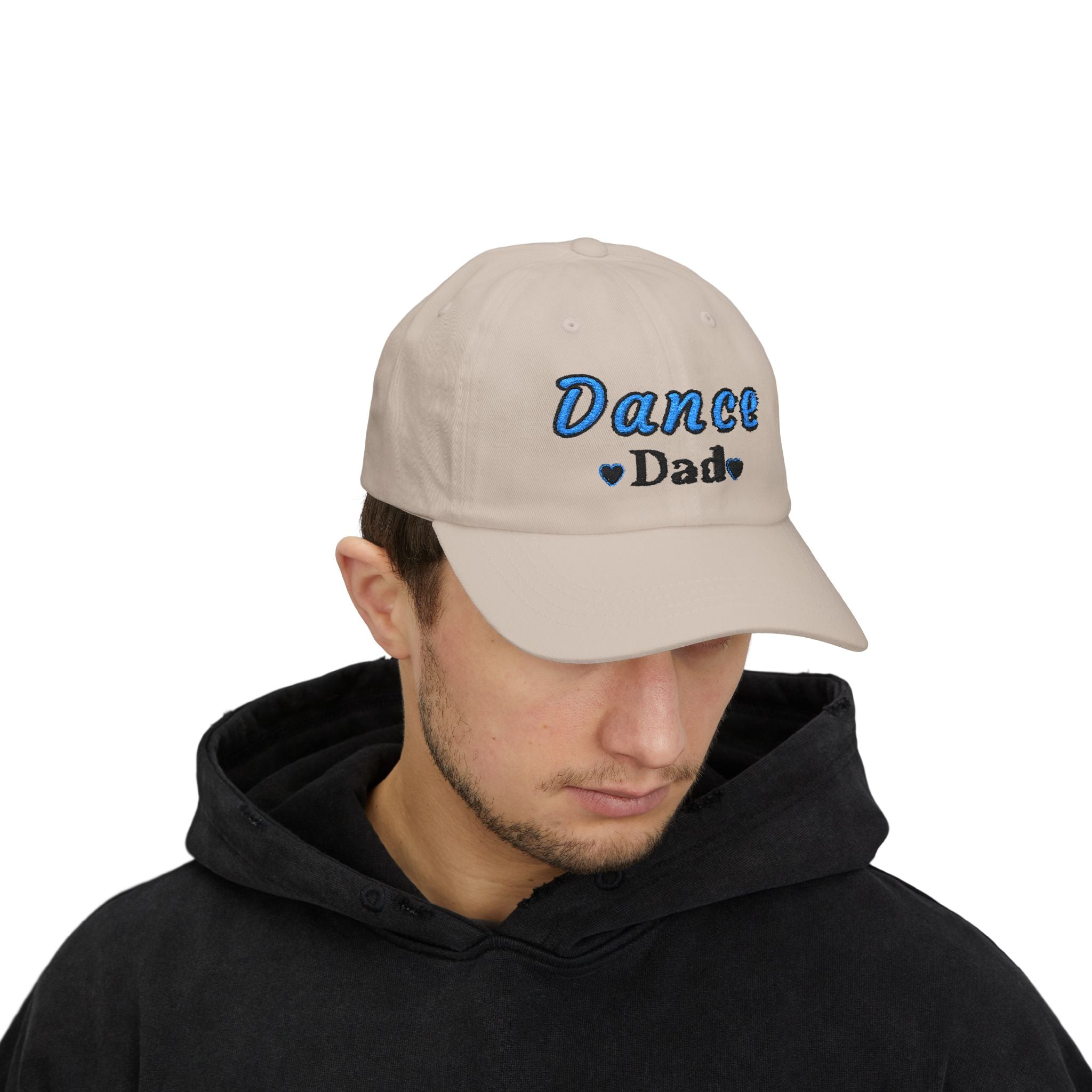 A man wearing a stone baseball cap with Dance Dad embroidered on the front.