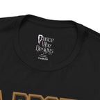 Close-up of a black crewneck t-shirt's inner neck label printed with the brand Dance Vibe Designs logo above the care instructions.