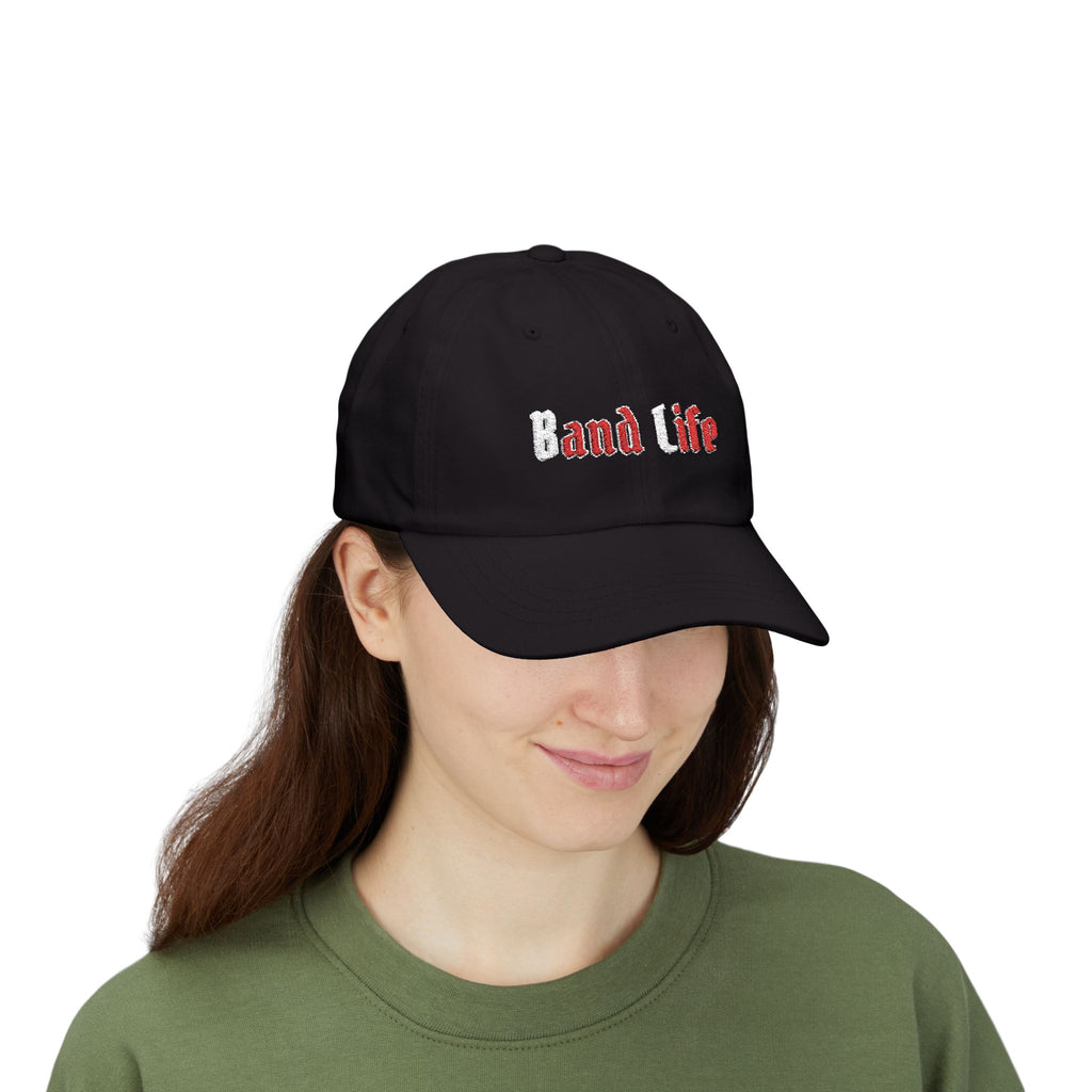 Woman wearing a black cap with an embroidered Band Life text.