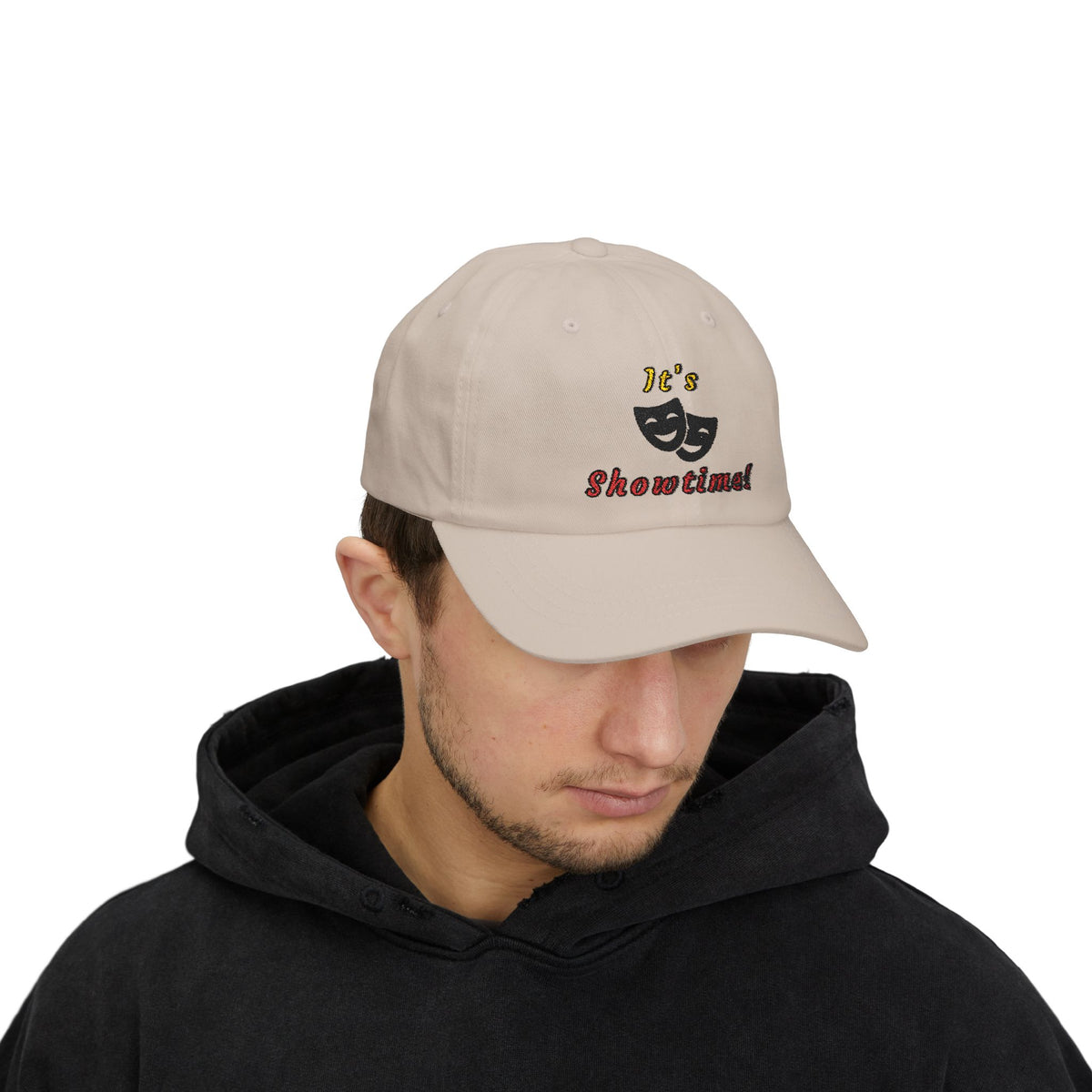 Man wearing a stone embroidered classic dad cap hat with an It's Showtime text and graphic 