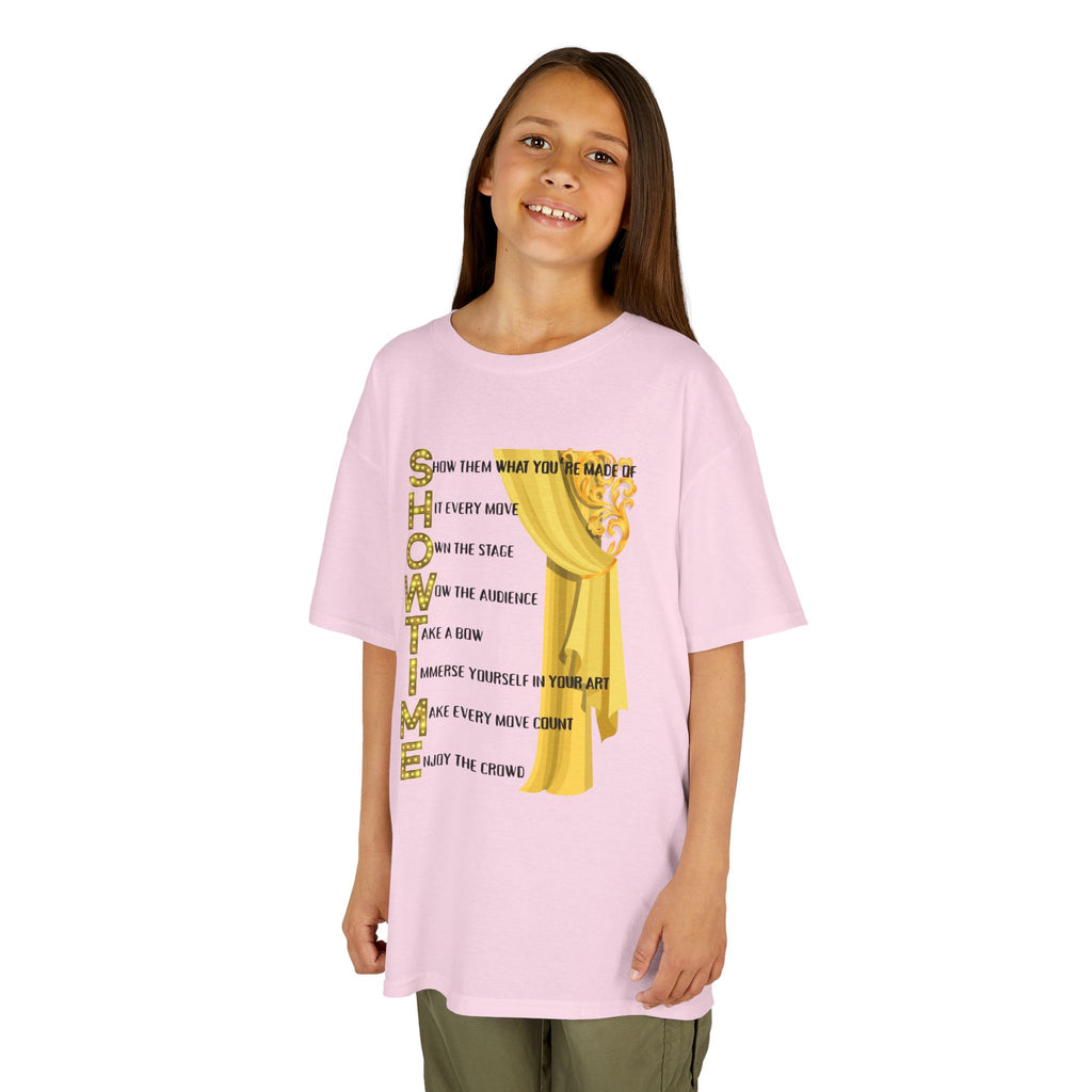 Young girl wearing a youth Gildan 5000B heavy cotton t-shirt in light pink with a Showtime text and graphic 