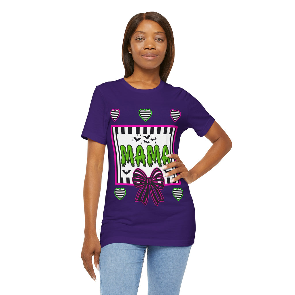 A woman wearing a purple t-shirt featuring a colorful Beetlejuice inspired Halloween-themed graphic with MAMA on the front.