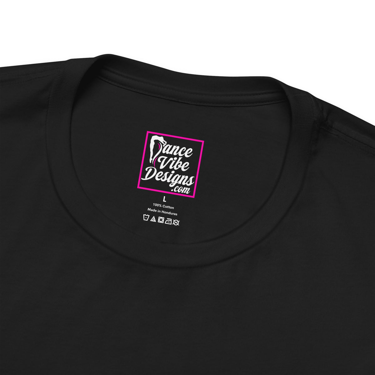 Close up view of a Dance Vibe Designs custom neck label above t-shirt care instructions.