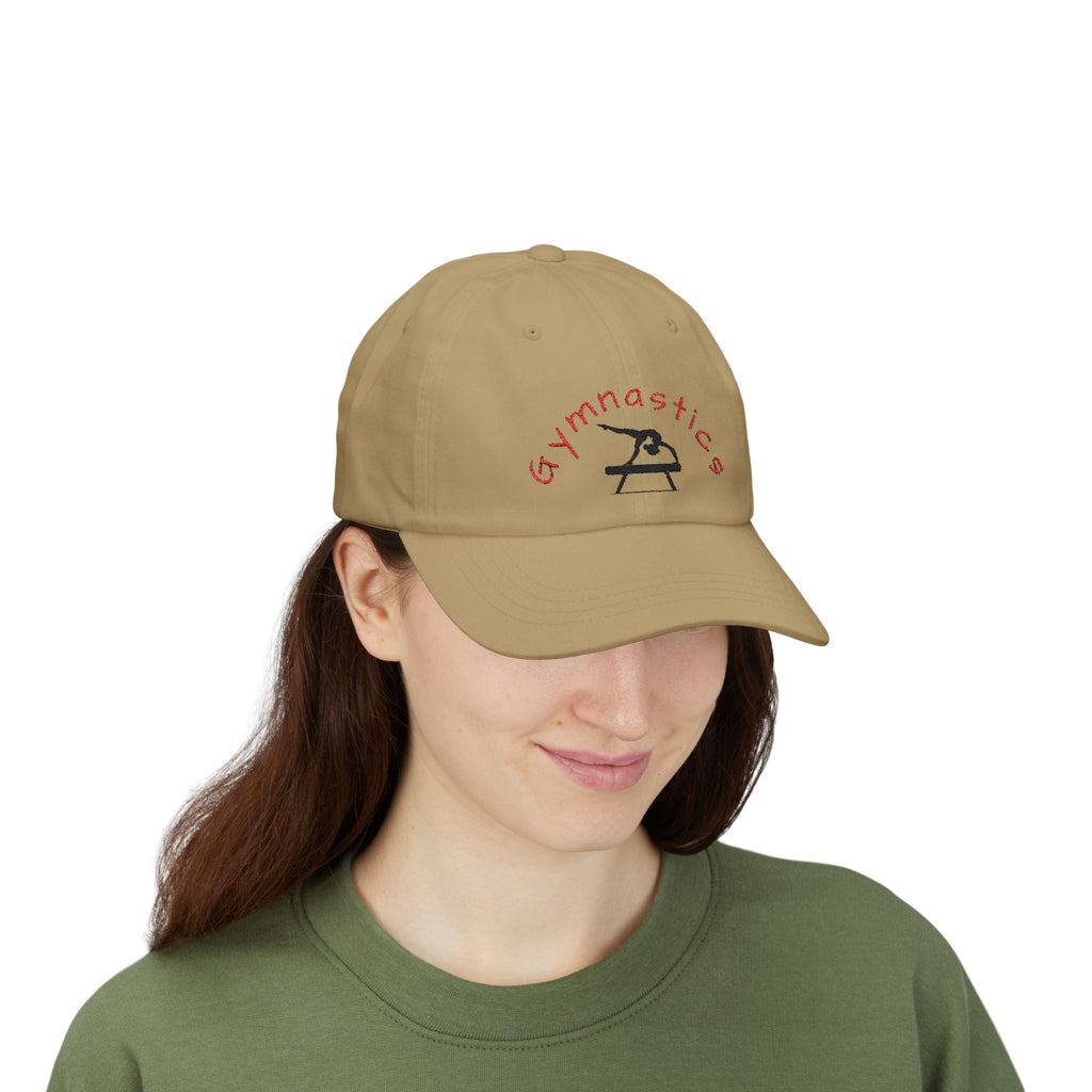 Woman wearing a khaki embroidered classic dad cap hat with a Gymnastics text and graphic 