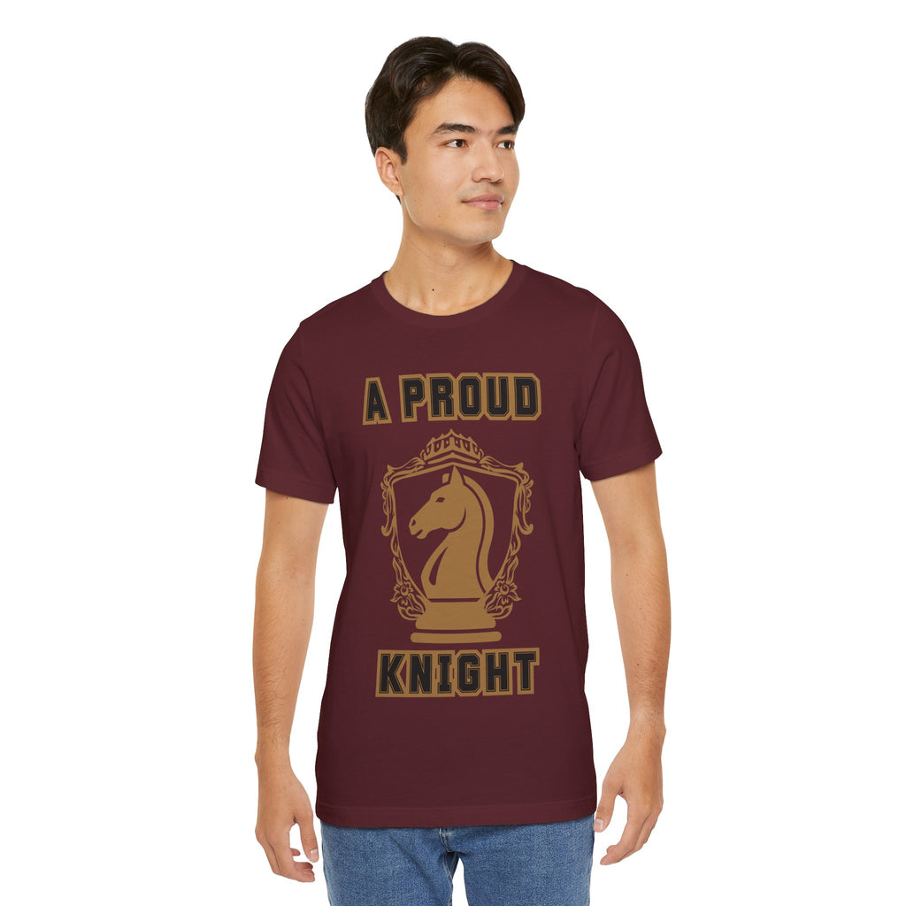 Man wearing a maroon graphic T-shirt with a gold chess knight design and the words A PROUD KNIGHT on the front.
