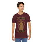 Man wearing a maroon graphic T-shirt with a gold chess knight design and the words A PROUD KNIGHT on the front.