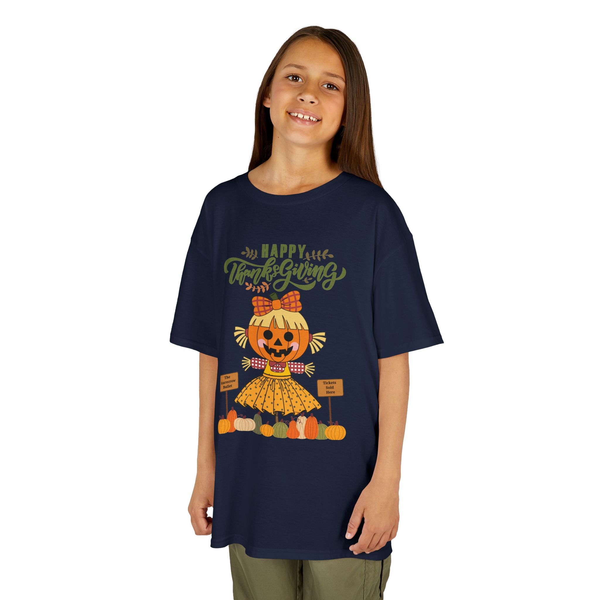 Young girl wearing a navy Thanksgiving t-shirt with a scarecrow ballerina design and a Happy Thanksgiving text.