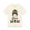 A natural short-sleeve crewneck t-shirt featuring a Cheer Mom silhouette graphic print with text.