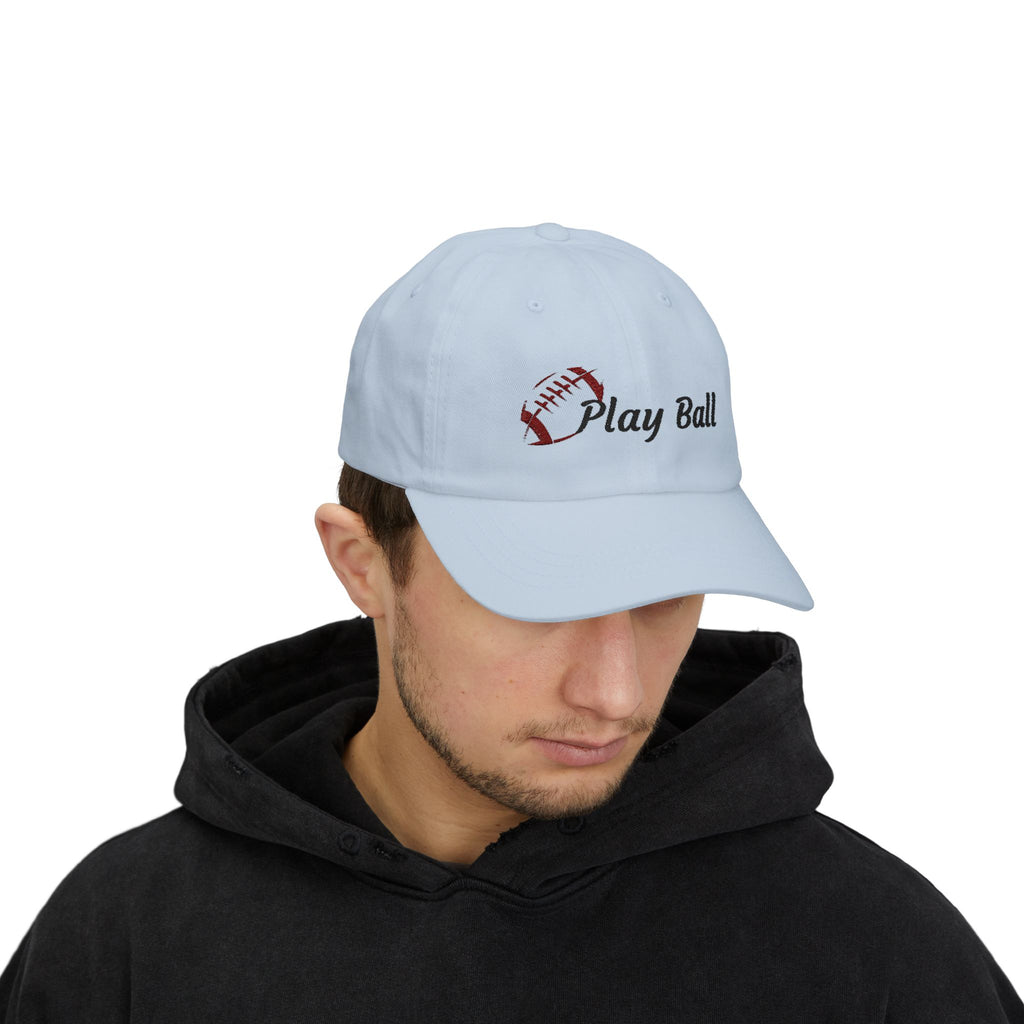 Man wearing a light blue embroidered classic dad cap hat with Play Ball text and football graphic