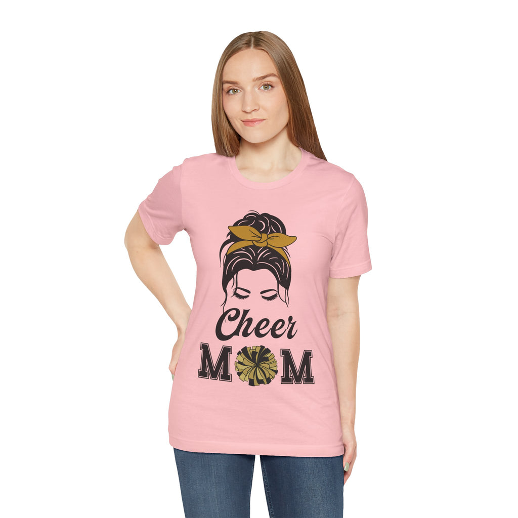 Woman wearing a pink short-sleeve crewneck t-shirt featuring a Cheer Mom silhouette graphic print with text.