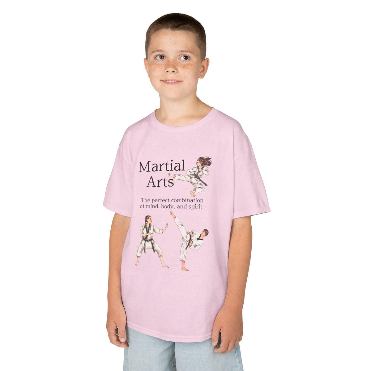 Young boy wearing a youth Gildan 5000B heavy cotton t-shirt in light pink with a Martial Arts text and graphic
