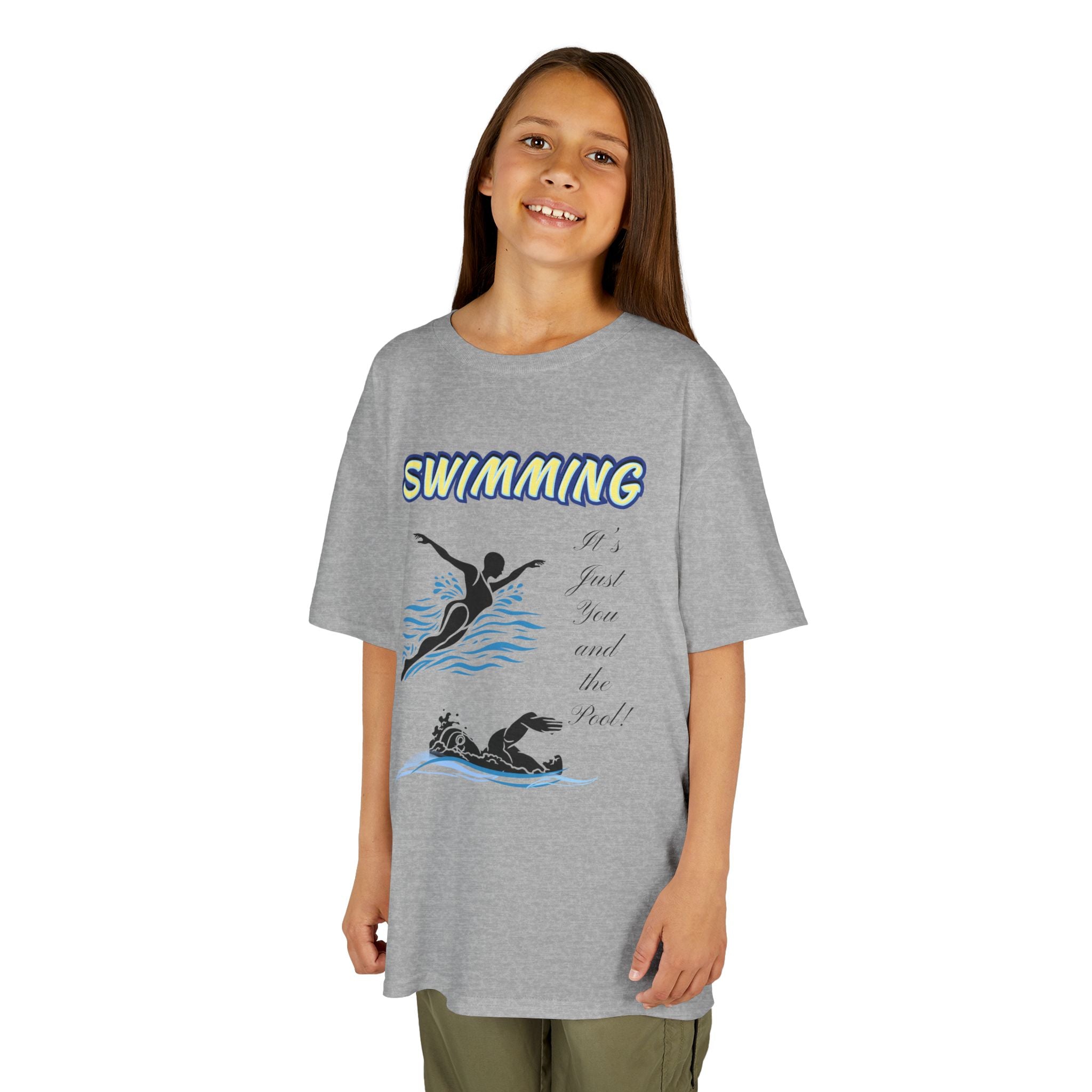 Young girl wearing a youth Gildan 5000B heavy cotton t-shirt in sport grey with a Swimming text and graphic