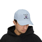 Man wearing a light blue embroidered classic dad cap hat with Let's Bowl text and graphic
