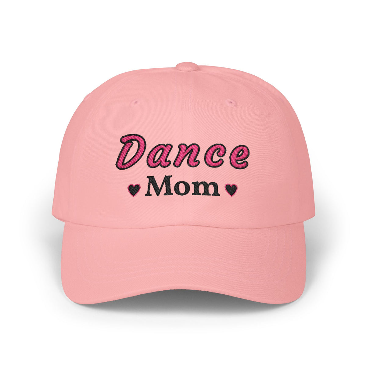 A pink baseball cap featuring the embroidered text Dance Mom on the front. 