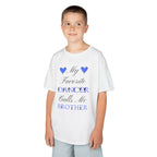 A young boy wearing a white t-shirt with a graphic that reads My Favorite Dancer Calls Me Brother.