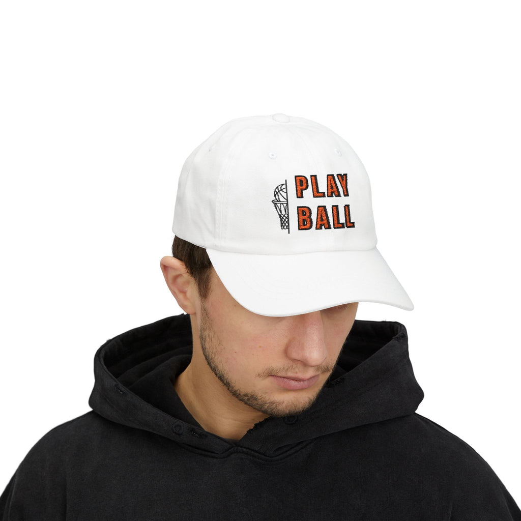Man wearing a white embroidered classic dad cap hat with Play Ball text and basketball graphic 