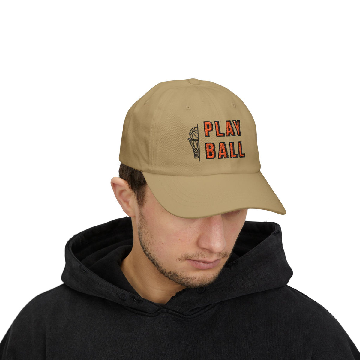 Man wearing a khaki embroidered classic dad cap hat with Play Ball text and basketball graphic 