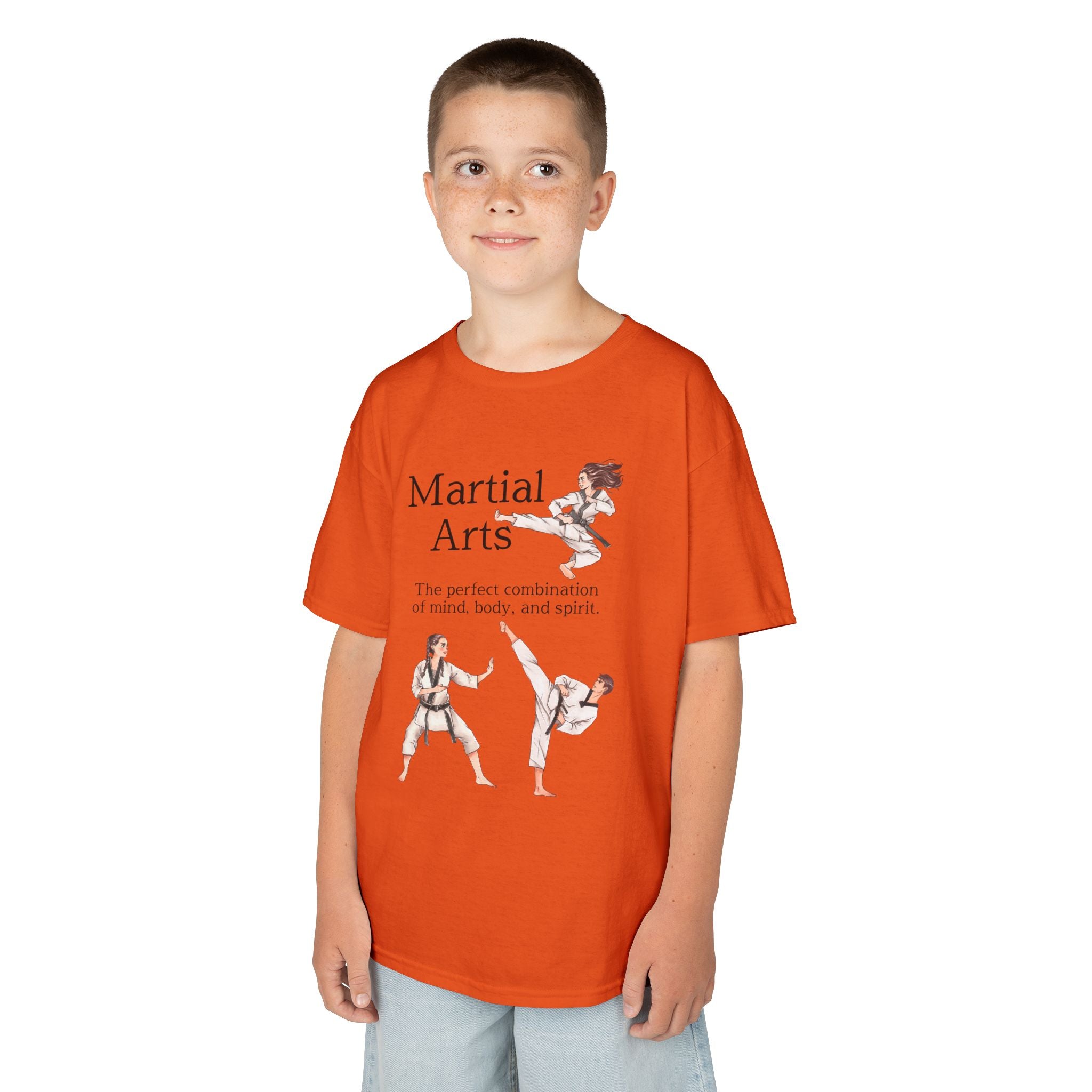 Young boy wearing a youth Gildan 5000B heavy cotton t-shirt in orange with a Martial Arts text and graphic