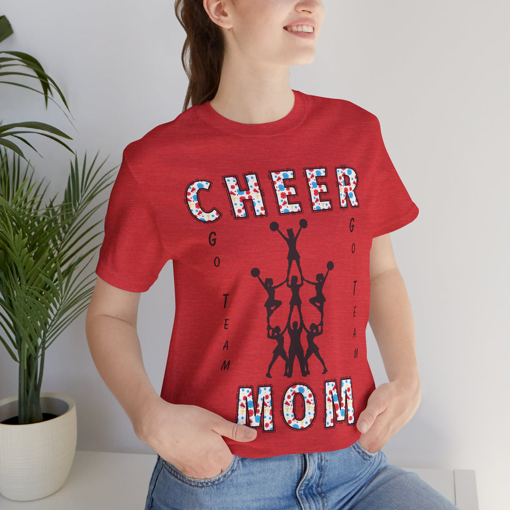 A woman wearing a heather red graphic t-shirt with CHEER GO TEAM MOM text and graphic on the front.