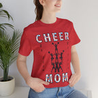 A woman wearing a heather red graphic t-shirt with CHEER GO TEAM MOM text and graphic on the front.