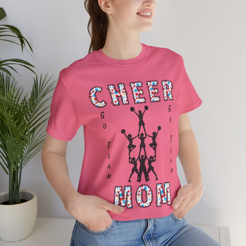 A woman wearing a charity pink graphic t-shirt with CHEER GO TEAM MOM text and graphic on the front.