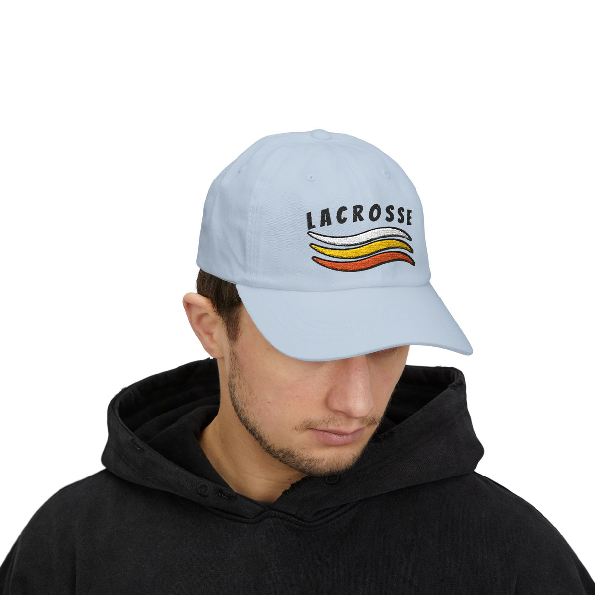 Man wearing a light blue embroidered classic dad cap hat with a Lacrosse text and graphic
