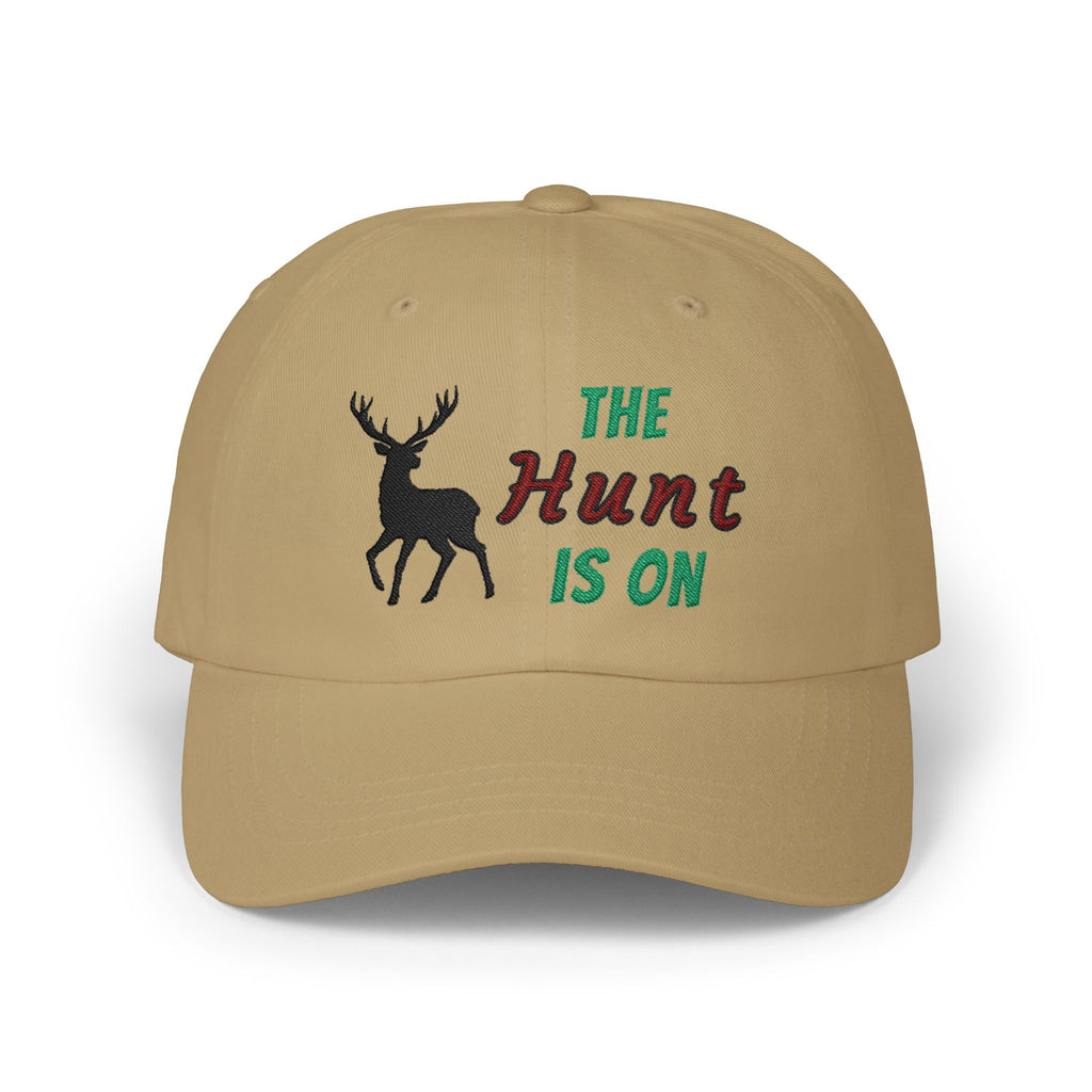 Khaki cap with an embroidered deer silhouette and The Hunt Is On text.
