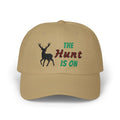 Khaki cap with an embroidered deer silhouette and The Hunt Is On text.